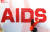 한국에이즈퇴치연맹 관계자가 에이즈 예방을 위한 퍼포먼스 차원에서 붉은 콘돔으로 `AIDS&#39; 영문 글자를 만들고 있다. [연합뉴스]