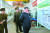 북한 김정은이 지난 8월 국방과학원 화학재료연구소를 찾아 &#39;4D탄소/탄소복합재료&#39; 공정을 나열한 설명판 앞에 서 있다. [연합뉴스]
