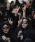 [BAHRAIN-PROTESTS/KILLIN]Women show the victory sign during the funeral procession for Hussam al-Haddad, who died from birdshot wounds, in Muharraq, north of Manama, August 18, 2012. A 16-year-old protester was killed after what opposition activists in Bahrain said was a &#34;brutal attack&#34; by security forces, but which the Bahrain government described as a defensive response to a petrol bomb attack on police. The government identified the dead youth as 16-year-old Hussam al-Haddad, and said he had been among