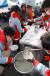 대한적십자사 임직원과 자원봉사자들이 2일 오전 서울역 광장에서 시무식으로 떡국나눔 봉사활동을 하고 있다. [연합뉴스]