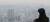 수도권 대부분 지역에 미세먼지 농도가 &#39;나쁨&#39;을 나타내고 있는 27일 오후 서울 중구 남산 N타워를 찾은 한 학생이 도심을 바라보고 있다. [뉴스1]
