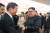 북한 노동당 기관지 노동신문이 28일 게재한 사진에서 김정은 노동당 위원장이 중국 베이징을 방문해 중국 측 인사들과 인사를 나누고 있다. [연합뉴스]