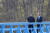문재인 대통령(오른쪽)과 김정은 국무위원장이 공동 식수를 마친 후 군사분계선 표식물이 있는 ‘도보다리’까지 산책을 하며 담소를 나누고 있다. [청와대사진기자단]