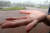 30일 오후 대구 북구 산격동 경북대학교에서 갑자기 소나기와 우박이 쏟아지자 한 학생이 우박 덩어리를 손바닥에 올려 보여주고 있다. [뉴스1]