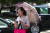 평양 시민이 지난달 31일 양산을 쓰고 휴대폰을 보며 거리를 걷고 있다. [타스=연합뉴스]