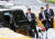 북한 경호원들이 김정은 국무위원장이 탑승한 차량 행렬 주위에서 이동하고 있다. [로이터=연합뉴스]
