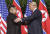 트럼프 대통령이 12일 오전 김정은 국무위원장과 싱가포르 센토사섬 카펠라호텔에서 첫 악수를 나누며 어깨를 만지고 있다.[AP=연합뉴스]