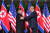 도널드 트럼프 미국 대통령이 김정은 북한 국무위원장과 악수를 하며서 왼손으로 김 위원장의 오른팔을 툭툭 치고 있다. [EPA=연합뉴스]