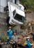 11일(현지시간) 일본 히로시마 현 구마노 타운에 폭우로 피해로 인해 차량이 담벼락에 걸쳐져 있다. [로이터=연합뉴스]