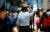 24일 서울 명동 거리에서 한 직장인이 휴대용 선풍기와 함께 거리를 걷고 있다. [연합뉴스]