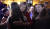 14일(현지시간) 미 역사상 최초의 트렌스젠더 주지사 후보로 지명된 크리스틴 홀퀴스트(가운데 빨간 재킷)가 자신의 승리가 공식 선언되자 지지자들과 포옹하며 기쁨을 나누고 있다.   [AP=연합]