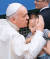 2014년 8월 대전 월드컵 경기장에서 열린 미사에 참석한 프란치스코 교황이 아이에게 입맞춤하고 있다. 교황은 방한 중 남북 분단에 대한 질문을 받곤 “가족과 형제들이 서로 만나지 못하는 데 대한 아픔을 저도 크게 느꼈다”면서도 “하나의 언어를 사용하는 게 희망의 요소”라고 했다. 기도도 제안했다. [중앙포토]