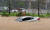 16일 오전 청주시 휴암동 곰두리체육관 인근 도로에 집중호우로 자동차가 물에 잠겨있다. [연합뉴스]