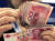 중국 은행원이 100위안짜리 지폐를 세고 있다. [AP=연합뉴스]