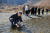 문재인 대통령이 20일 오전 김정은 국무위원장과 백두산 천지를 산책하던 중 천지 물을 물병에 담고 있다. 평양사진공동취재단