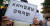 15일 오후 서울 성북구 동덕여대 본관 앞에서 열린 &#39;안전한 동덕여대를 위한 민주동덕인 필리버스터&#39;에서 학생들이 피켓을 들고 참가자 발언을 듣고 있다. [연합뉴스]
