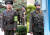 남북은 앞으로 각각 35명의 비무장 인원이 JSA 경비를 서게 된다. 지난 26일 북한 군인들이 &#39;판문점 민사경찰 27&#39;이라는 완장을 차고 근무하고 있다(왼쪽 사진). 오른쪽은 철모와 권총을 차고 근무하던 과거 북한국 모습.사진공동취재단   