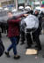  8일(현지시간) 벨기에 브뤼셀에서 경찰이 노란조끼 시위에 참가한 한 여성에게 최루액을 뿌리고 있다. [EPA=연합뉴스]