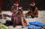 산타 모자와 비키니 수영복을 입은 관광객들이 25일(현지시간) 호주 시드니 본다이 비치에서 휴대폰을 보며 휴식을 취하고 있다. [AFP=연합뉴스] 