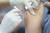 지난 10월 서울역 인근 노숙인 무료 급식소인 &#39;따스한 채움터&#39;에서 나눔진료봉사단 의료진이 노숙인과 쪽방촌 주민에게 무료로 독감 예방접종을 해주고 있다. [연합뉴스]