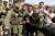  23일(현지시간) 베네수엘라와 콜롬비아 국경에서 구호물품 반입을 두고 군과 시민이 충돌했다. 콜롬비아 경찰이 부상당한 베네수엘라 군인을 부축하고 있다. [EPA=연합뉴스]