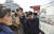  지난 27일 평양 시민들이 김 위원장의 베트남 방문 소식을 노동신문을 통해 보고있다. [로이터=연합뉴스]