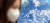 서울 지역에 사상 처음으로 닷새째 미세먼지 비상저감조치가 발령된 5일 오전 서울 중구 세종대로 한 건물 외벽에 걸린 푸른 지구 그림 앞으로 마스크를 쓴 시민이 지나고 있다. [연합뉴스]