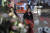 한 평양 여성이 &#39;국제부녀절&#39;을 맞아 선물용 꽃다발을 마련한 꽃집 앞을 지나가고 있다. [AP=연합뉴스]