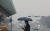 서울 및 수도권 지역에 초미세먼지 주의보가 발령된 12일 오전 서울 여의도에서 마스크와 우산을 쓴 시민이 발걸음을 옮기고 있다. [뉴스1]