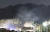 13일 서울 은평구 모델하우스 화재의 불씨가 옮겨붙은 북한산 일대에서 야간 화재 진압작업이 진행되고 있다. [연합뉴스]