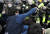27일 서울 여의도 국회 앞에서 민주노총 주최로 열린 전국노동자대회에서 참가자들이 경찰의 헬맷을 잡아당기고있다.[뉴시스]