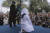 지난해 4월20일 인도네시아 반다 아체의 이슬람사원(모스크)에서 샤리아법 집행관이 얼굴을 가린 채 꿇어 앉는 여성 무슬림에게 채찍 태형을 가하고 있다. 이 여성은 성매매 혐의로 구속 수감돼 왔다. 이날 또다른 남녀 커플은 공공장소에서 애정 행각을 했다는 이유로 마찬가지로 공개 태형을 당했다. [AP=연합뉴스] 