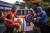 슈퍼 히어로 복장을 한 인도네시아 선거 관계자들이 16일(현지시간) 동자바 수라바야 지역에서 트럭을 타고 투표함을 옮기고 있다. [AFP=연합뉴스]
