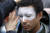 지난 해 10월 31일 미국 아마존 본사 앞에서 시위대 중 한 명이 아마존의 안면인식 프로그램 &#39;레코그니션&#39;에 반대하는 의미로 얼굴을 하얗게 칠하고 있다. [AP=연합뉴스]