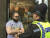 폴 크라우더로 알려진 밀크셰이크 투척자가 현장에서 경찰에 체포돼 수갑을 차고 있다. [AP=연합뉴스]
