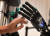 한 여성이 예민하게 반응하는 로봇손을 살펴보고 있다. [AFP=연합뉴스]