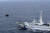 지난 5월 일본 해안경비대 배가 북한 어선을 배타적 경제수역(EEZ) 밖으로 밀어내고 있다. [AP=연합뉴스]