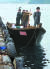 지난 15일 북한 선원 4명이 탄 어선이 연안에서 조업 중인 어민의 신고로 발견됐다는 정부 당국의 발표와 달리 삼척항 부두에 정박했다고 KBS가 18일 보도했다. 사진은 당시 삼척항 부두에 정박한 북한어선과 어민. [뉴스1]