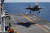 지난해 3월 23일 일본 오키나와 남쪽 해상에서 미국 해병대의 F-35B 스텔스 전투기가 강습상륙함에 수직 착륙하고 있다. 일본도 이즈모급 호위함 2척의 갑판을 개조해 F-35B를 탑재할 계획이다. [로이터=연합뉴스] 
