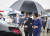 G20 정상회의에 참석하는 문재인 대통령과 김정숙 여사가 27일 오후 오사카 간사이 국제공항에 도착한 공군 1호기에서 차량으로 이동하고 있다. 문 대통령이 우산을 들고 김정숙 여사를 차량으로 안내하고 있다. [연합뉴스]