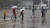 장마전선의 북상으로 부산지방에 호우주의보가 내려진 지난 26일 오후 부산 해운대구 벡스코를 찾은 관광객들이 우산을 쓴 채 광장을 지나고 있다. 송봉근 기자