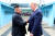 북한 노동신문은 지난달 30일 도널드 트럼프 미국 대통령과 김정은 북한 국무위원장이 판문점에서 악수하는 모습을 1일 보도했다. 북측에서 본 사진 뒤편에 남측 평화의집이 보인다. [노동신문=뉴시스]