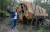 지난 6월 7일 한 관광객이 체르노빌 &#39;금지구역&#39; 내 버려진 버스를 배경으로 기념사진을 찍고 았다. [EPA=연합뉴스]