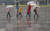 부산지방에 호우주의보가 내려진 26일 오후 부산 해운대구 벡스코를 찾은 관광객들이 우산을 쓴 채 광장을 지나고 있다. 송봉근 기자