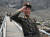 24일 한 북한 안내원이 카메라를 향해 밝은 표정으로 거수 경례를 하고 있다. [타스=연합뉴스]