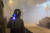 4일(현지시간) 홍콩 도심에서 시위대에 발사된 최루탄 속에서 전경 한 명이 걸어가고 있다. [AFP=연합뉴스] 