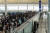시위대가 13일 홍콩국제공항 출구 게이트를 막으면서 여행객들이 큰 불편을 겪었다. [AFP=연합뉴스]
