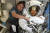 NASA가 지난 4일(현지시간) 공개한 사진속에 우주복을 입은 크리스티나 코흐(오른쪽)와 제시카 마이어가 국제우주정거장에서 서로의 주먹을 맞대고 있다. [AP=연합뉴스]