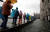 우비와 일회용 장화를 신은 관광객들이 12일(현지시간) 침수된 베네치아 광장을 지나고 있다. [AP=연합뉴스]