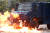 17일 시위대가 던진 화염병에 홍콩 경찰 차량이 불타고 있다. [로이터=연합]